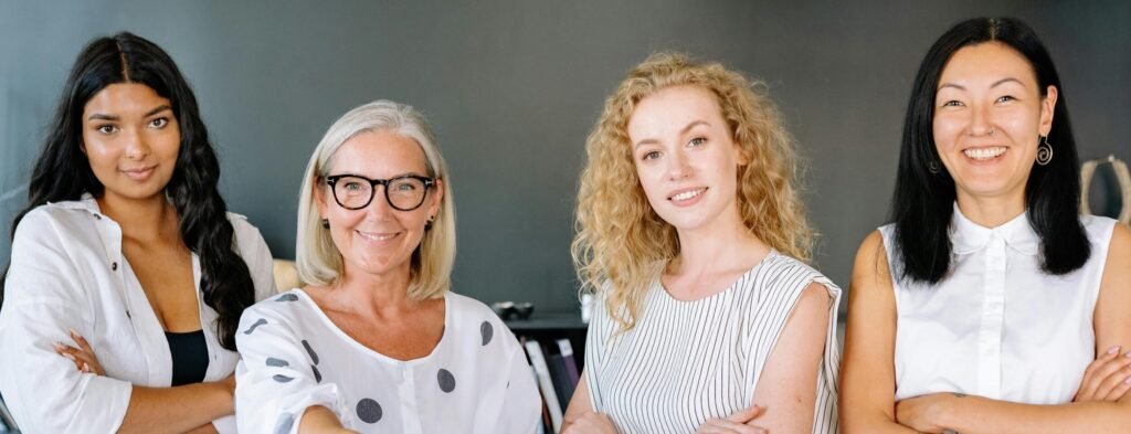 Smiling diverse group of women, of all ages and all ethnicities. This demonstrates inclusivity and services for all ages and demographics.